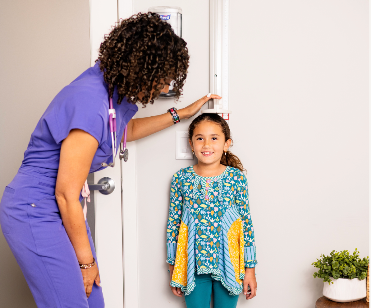 Dr. Penelope Pauley measures a young girl’s height during a pediatric endocrinology visit at The Endocrine Co. in Orlando, Florida.